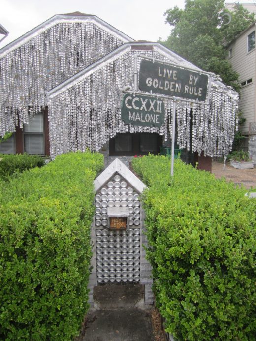 A house covered entirely in squashed beer cans